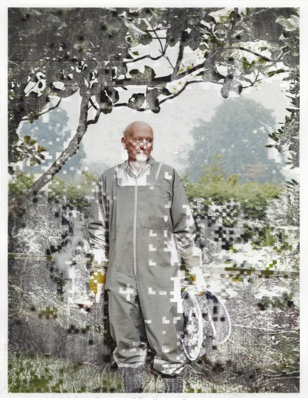 A beekeeper is standing aloof in his garden. His face, body, and surroundings are eroding away around him. Transparent vinyl has been cut into a detailed pixelated mask used on the print during the alcohol bath it has taken. Paper towels have been used during the drying process which has left textured marks in the exposed plotter ink.