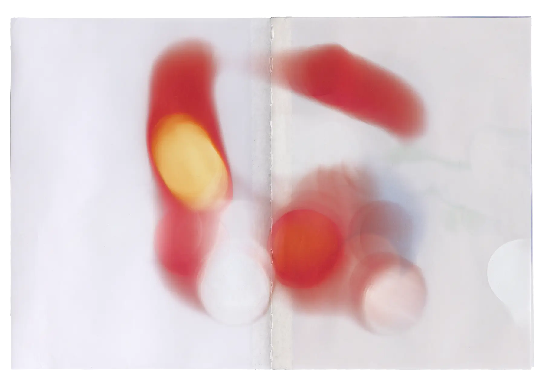 First spread of the Bloom book, in this spread is the blur and extracted bloom of a car’s rear brake light. Notably, the images were printed using a UV printer directly onto the pre-bound pages. As a result, the binding thread in the book's seam has taken on some of the color from the images.