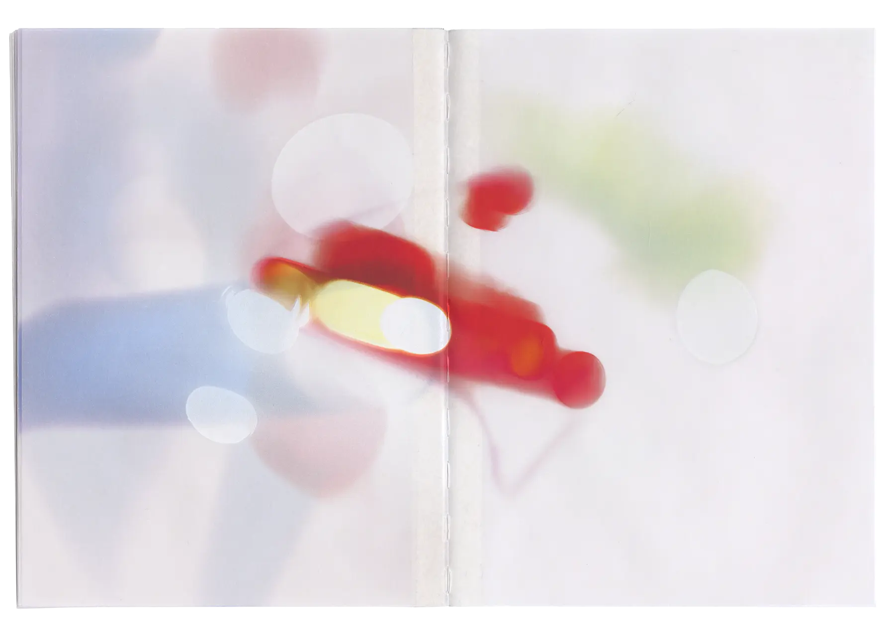 Fifteenth spread of the Bloom book, in this spread is the blur and extracted bloom of a white car’s red rear brake light. Notably, the images were printed using a UV printer directly onto the pre-bound pages. As a result, the binding thread in the book's seam has taken on some of the color from the images.