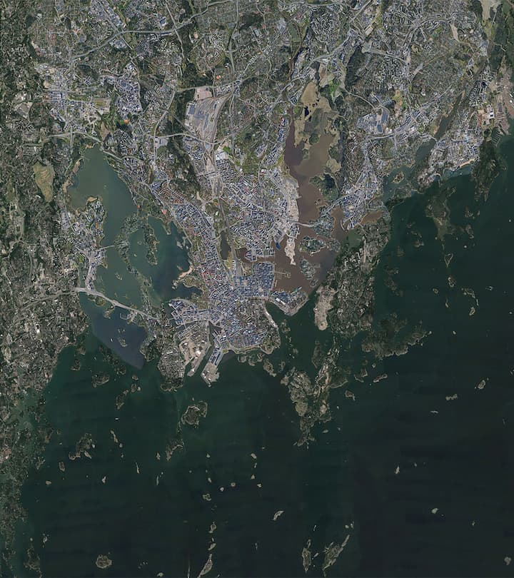 Triplet of images, starting with a satellite view of Helsinki, unaltered in the first frame, the image then undergoes a striking transformation, compressing horizontally, and with the transformation the city’s greenery—parks, forests, and other natural areas—seemingly dissolves away as if subtly edged out of existence. This visual shift represents a real-world human mindset: the prioritization of human living space over natural landscapes. When the image expands, revealing newfound space, the instinct isn't to restore nature. Instead, it's seen as room for more urban development, reinforcing the narrative of human dominance and expansion over nature.